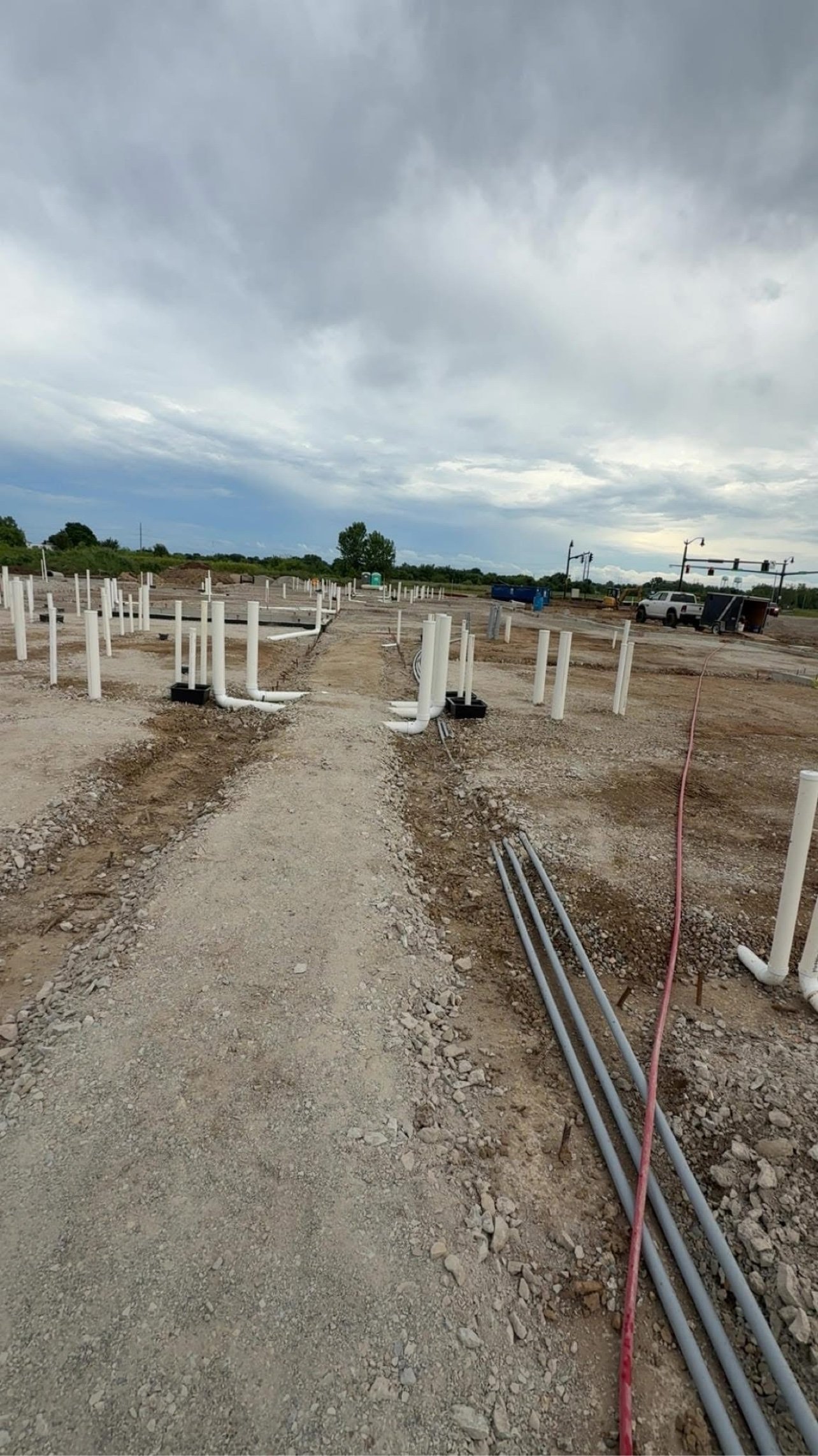 Underground utilities roughed in at a new commercial construction site ahead of termite pre-treatment